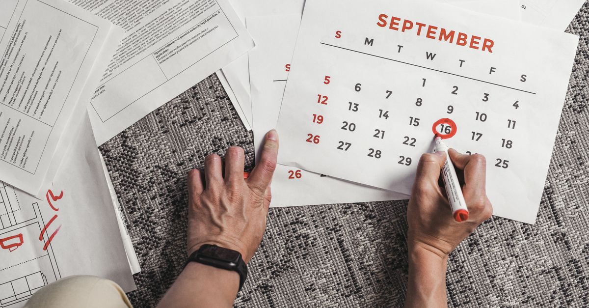 Hands circling a date on a paper calendar while counting months in perimenopause