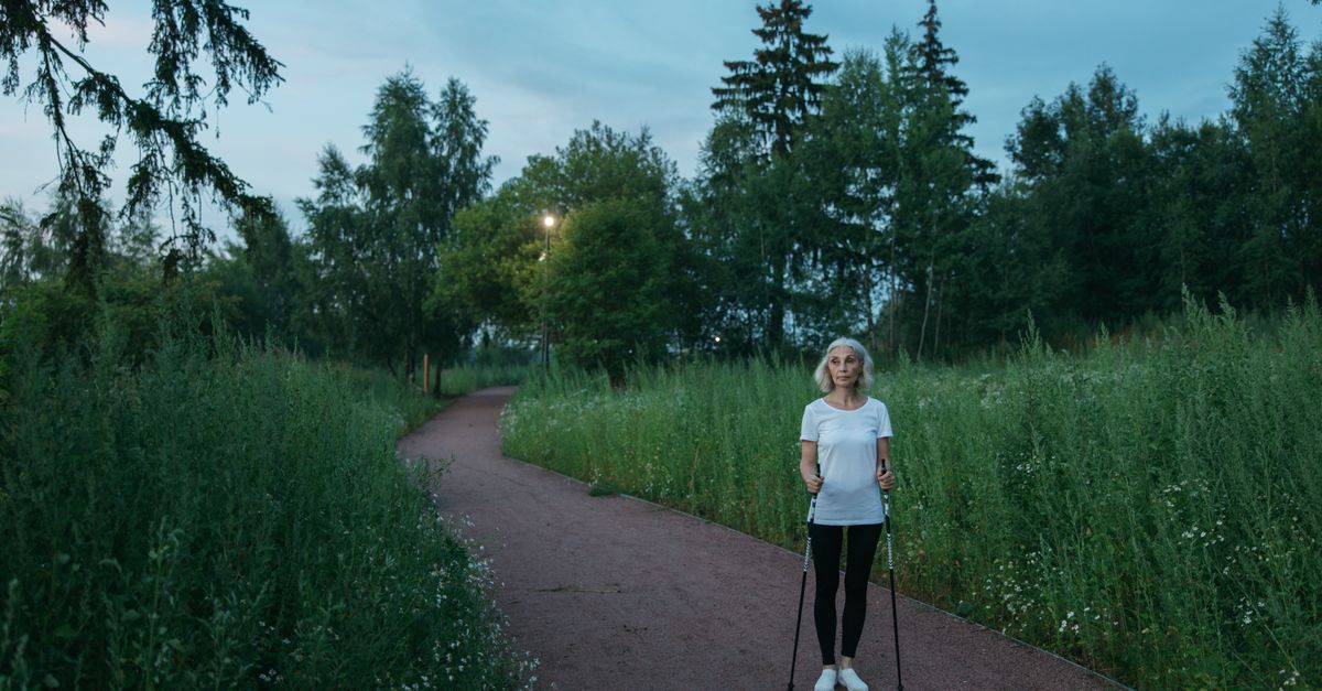 Woman walking a path at dusk, illustrating why palpitations during exertion are assessed differently